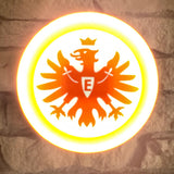 „Runde Lampe mit großem SGE-Adlerlogo vor weißem Hintergrund.“